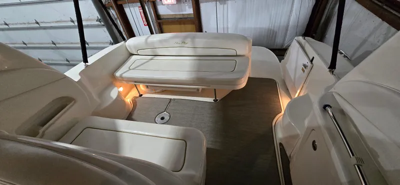 Slide: The Image of 2002 Sea Ray 300 Sundancer interior with cushioned seating and ambient lighting. - 21