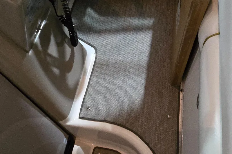 Slide: The Image of Interior view of 2002 Sea Ray 300 Sundancer boat with carpeted flooring. - 24