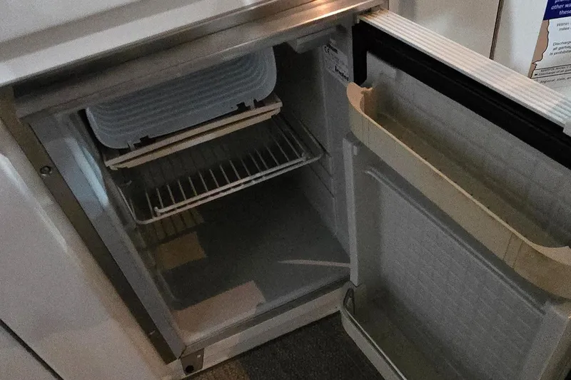 Slide: The Image of Open refrigerator inside a 2002 Sea Ray 300 Sundancer boat. - 26
