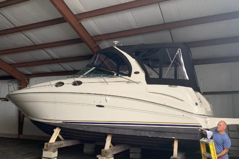 Slide: The Image of 2002 Sea Ray 300 Sundancer boat in storage, side view. - 3