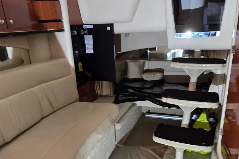 Slide: The Image of Interior of 2002 Sea Ray 300 Sundancer yacht with beige seating and modern design. - 37