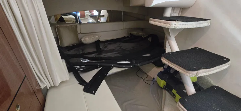 Slide: The Image of Interior cabin of 2002 Sea Ray 300 Sundancer with seating and steps. - 38