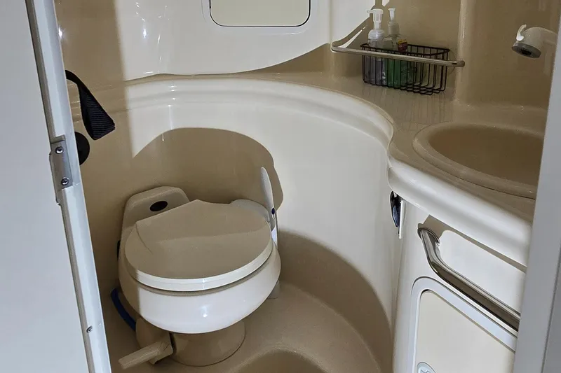 Slide: The Image of 2002 Sea Ray 300 Sundancer bathroom with toilet and sink. - 41