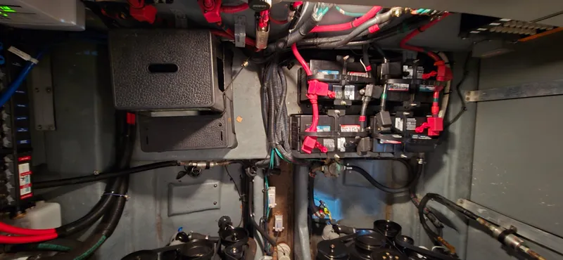 Slide: The Image of Engine compartment of a 2002 Sea Ray 300 Sundancer with wiring and components. - 44