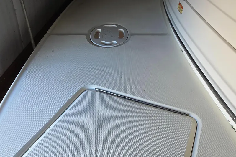 Slide: The Image of 2002 Sea Ray 300 Sundancer boat deck, featuring textured surface and hatch. - 9