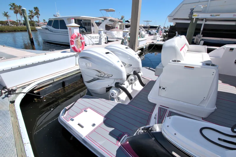 Slide: The Image of 2021 Regal 36 XO boat with twin Yamaha engines docked at a marina. - 17