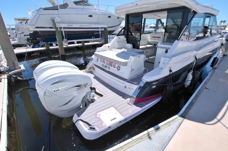 Slide: The Image of 2021 Regal 36 XO boat docked, featuring dual outboard engines and spacious deck. - 19