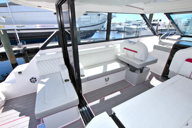 Slide: The Image of 2021 Regal 36 XO yacht interior with white seating and modern design. - 22