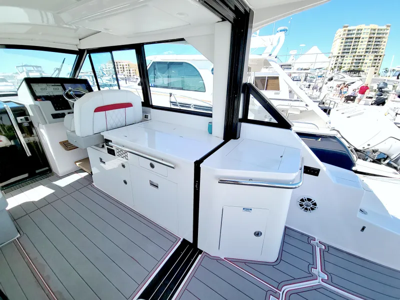 Slide: The Image of 2021 Regal 36 XO yacht interior with modern helm and sleek design at marina. - 25