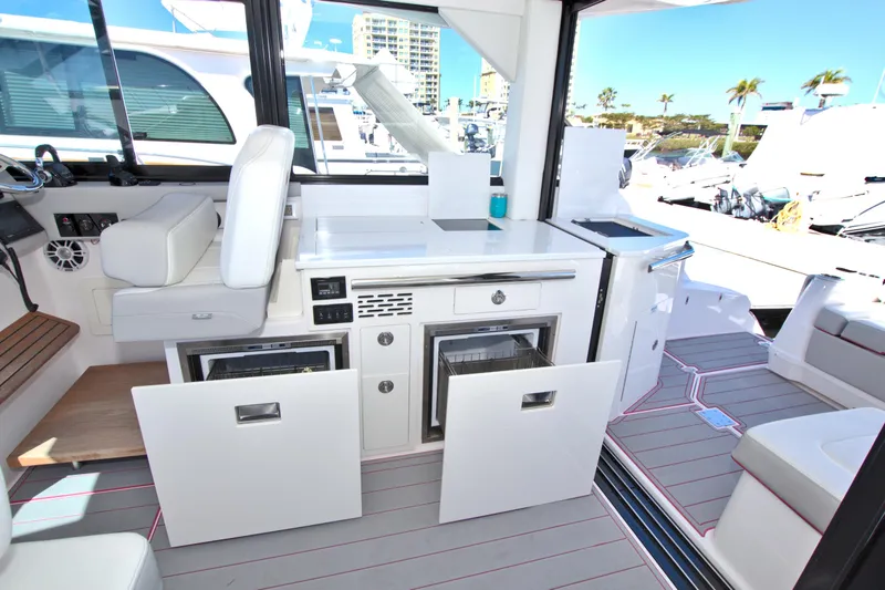 Slide: The Image of 2021 Regal 36 XO yacht interior with modern kitchen and seating area. - 26