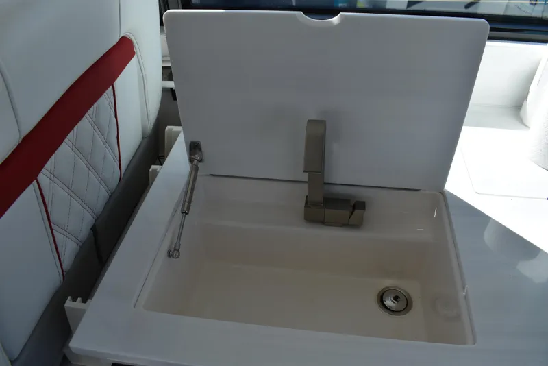 Slide: The Image of 2021 Regal 36 XO yacht sink with modern faucet and white cover. - 29