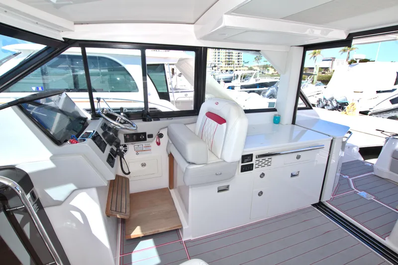 Slide: The Image of 2021 Regal 36 XO yacht interior with modern helm and seating area. - 30