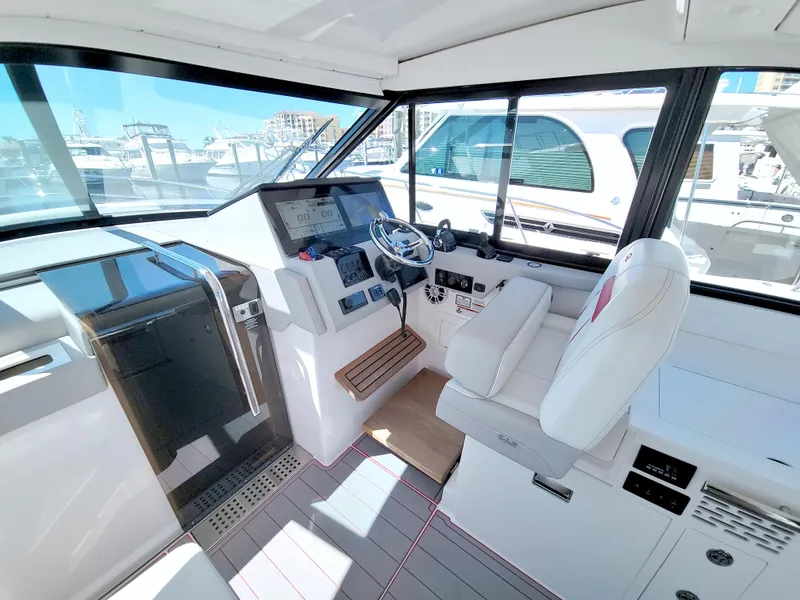 Slide: The Image of Helm of 2021 Regal 36 XO yacht with modern controls and white seating. - 32