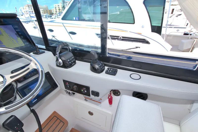 Slide: The Image of Helm of 2021 Regal 36 XO boat with modern controls and navigation equipment. - 34