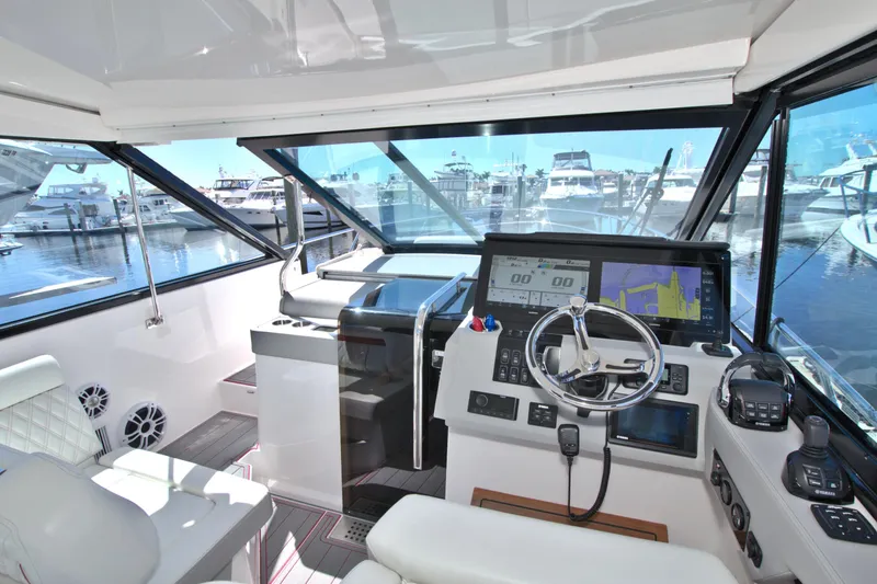 Slide: The Image of 2021 Regal 36 XO yacht cockpit with modern navigation system and marina view. - 35