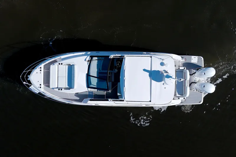 Slide: The Image of Aerial view of 2021 Regal 36 XO boat cruising on dark water. - 4