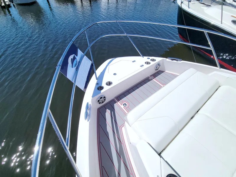 Slide: The Image of 2021 Regal 36 XO boat deck with seating, docked on calm water. - 40