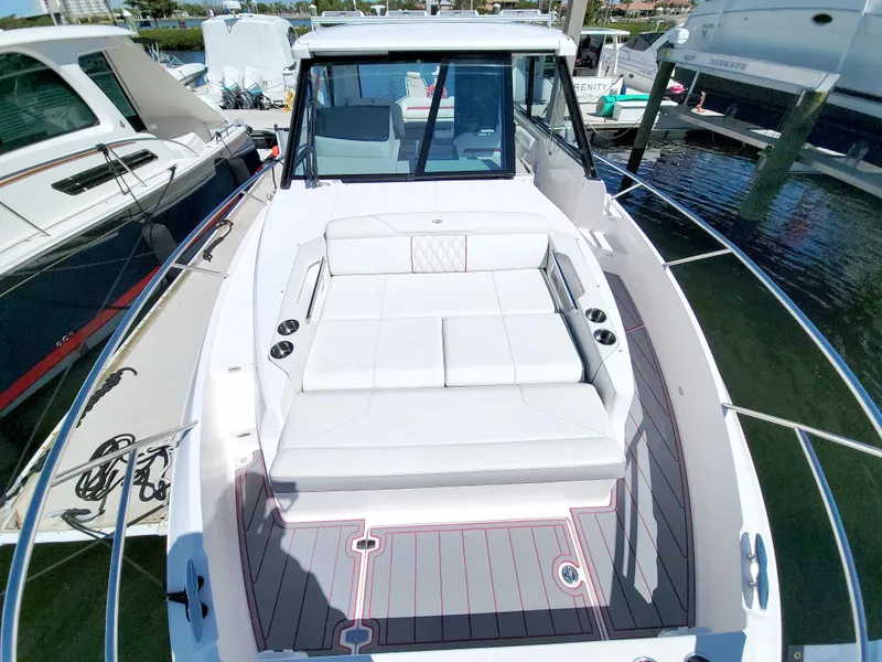 Slide: The Image of 2021 Regal 36 XO boat with spacious deck and seating, docked at marina. - 41