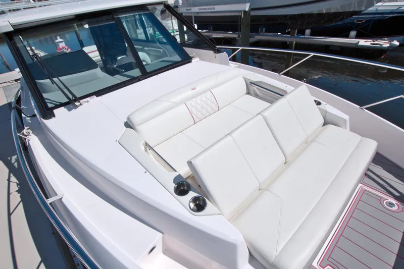 Slide: The Image of 2021 Regal 36 XO boat with white seating and sleek design. - 42