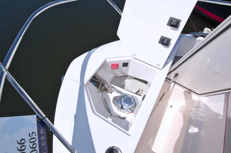 Slide: The Image of 2021 Regal 36 XO boat anchor compartment with open hatch, showcasing anchor and chain. - 45