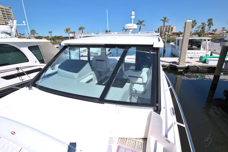 Slide: The Image of 2021 Regal 36 XO boat docked at marina, featuring sleek design and spacious interior. - 47