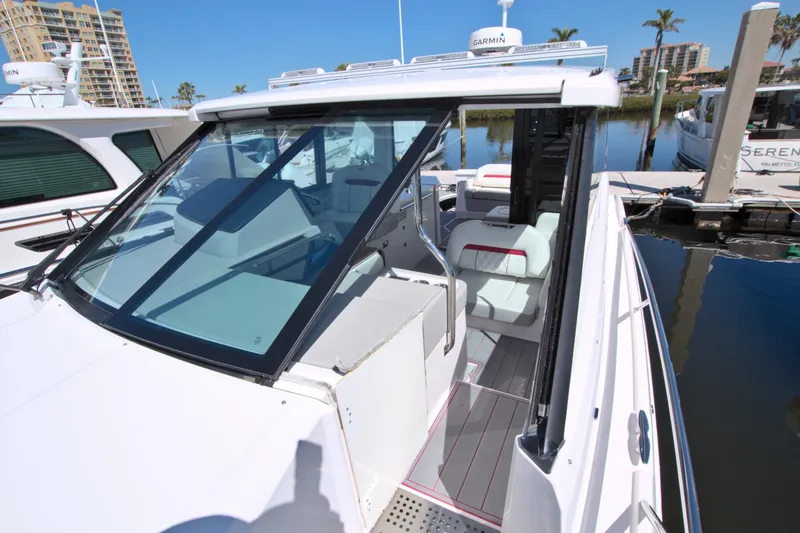 Slide: The Image of 2021 Regal 36 XO boat with sleek design docked at marina. - 48