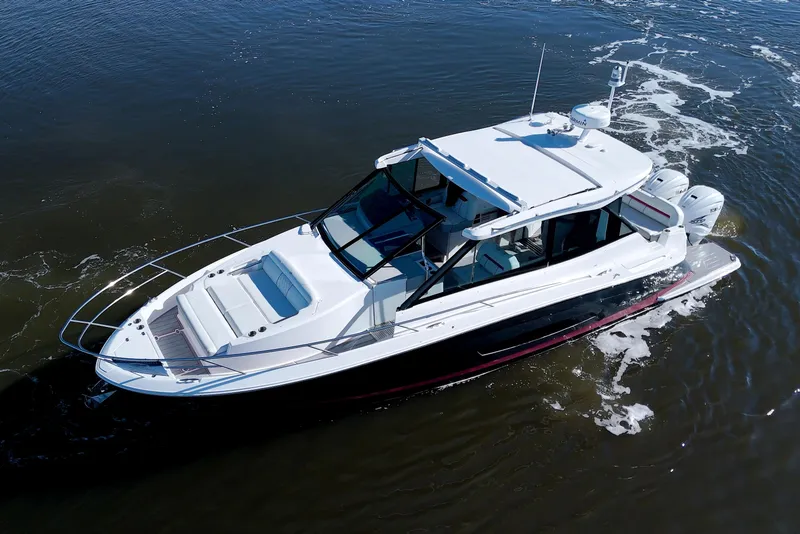Slide: The Image of 2021 Regal 36 XO boat cruising on open water, aerial view. - 5