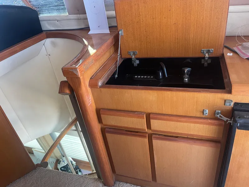 Slide: The Image of 1999 Viking 58 EB yacht interior with wooden cabinetry and built-in stove. - 11