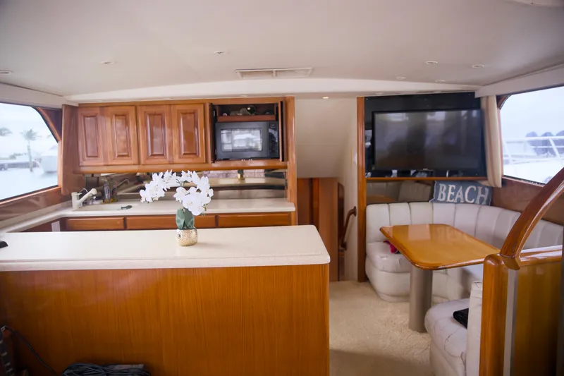 Slide: The Image of Interior of 1999 Viking 58 yacht with kitchen and dining area. - 13