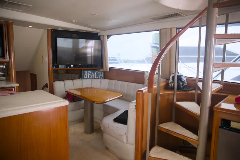 Slide: The Image of Interior of 1999 Viking 58 yacht with cozy seating and spiral staircase. - 14