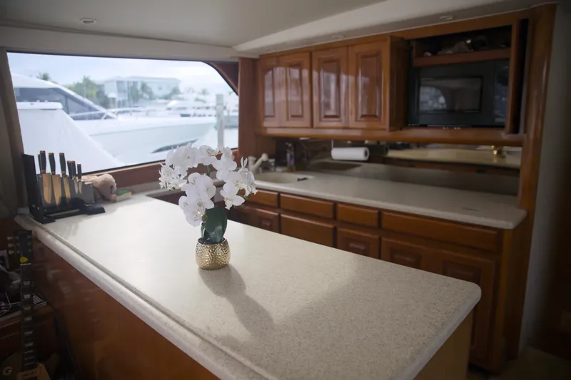 Slide: The Image of Luxurious kitchen interior of a 1999 Viking 58 yacht with wooden cabinets and countertop. - 17