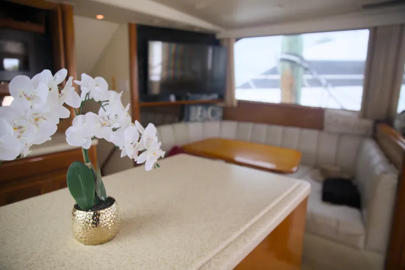 Slide: The Image of Interior of 1999 Viking 58 yacht with elegant decor and white orchid centerpiece. - 18