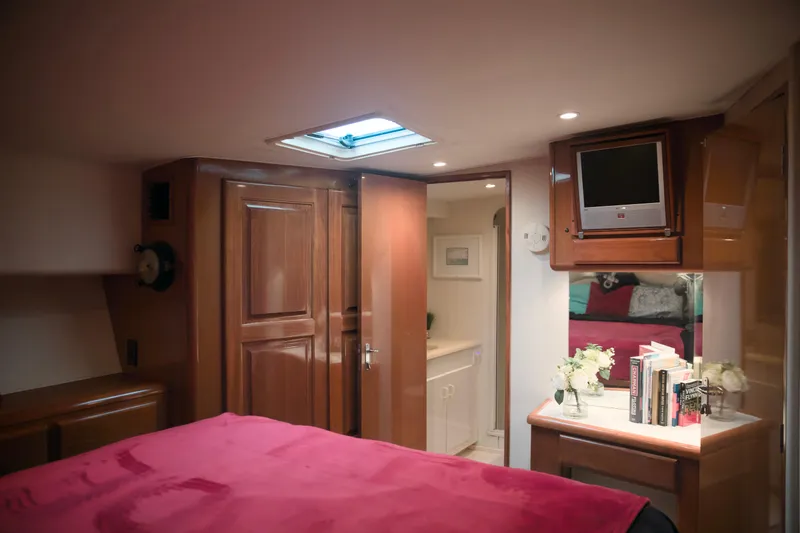 Slide: The Image of Luxurious interior of a 1999 Viking 58 yacht with wood finishes and cozy decor. - 29