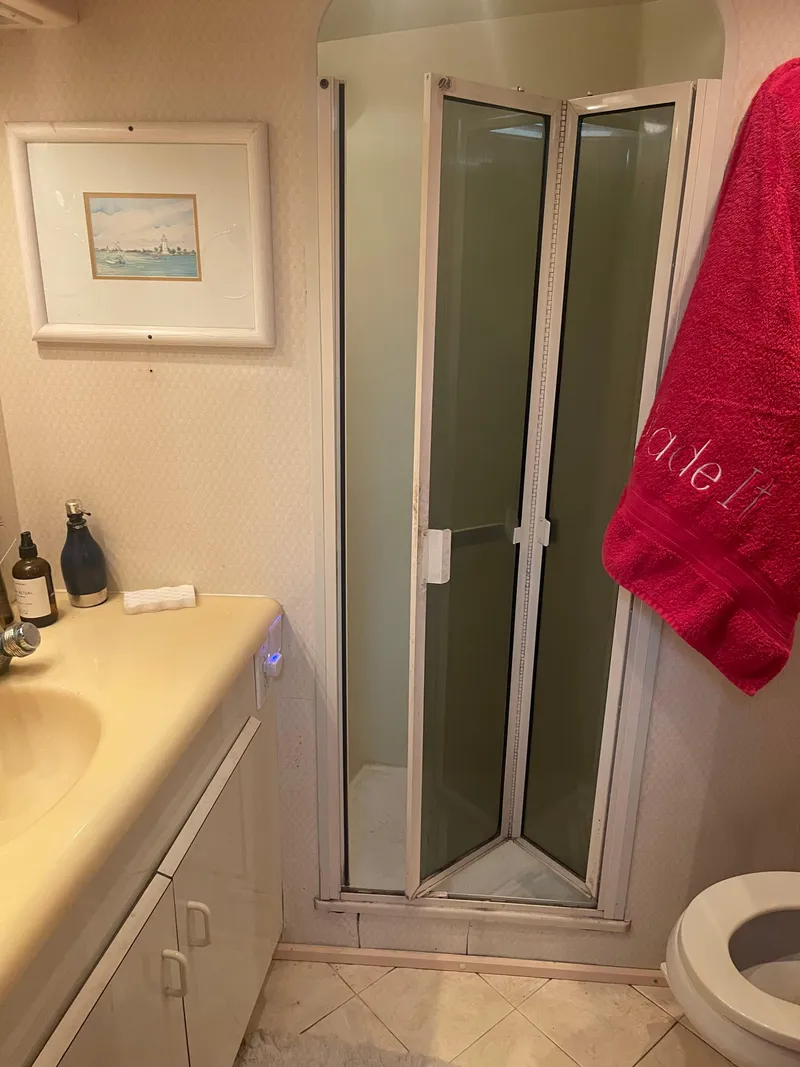 Slide: The Image of Bathroom interior of a 1999 Viking 58 EB yacht with shower and sink. - 30