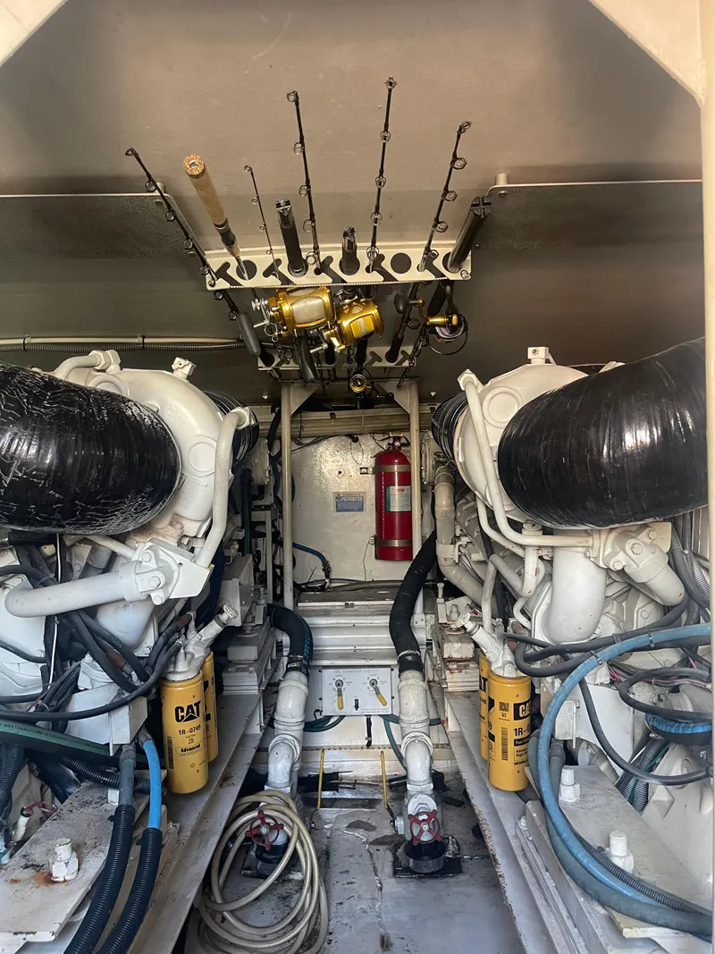 Slide: The Image of Engine room of 1999 Viking 58 EB yacht with fishing rods and equipment. - 32