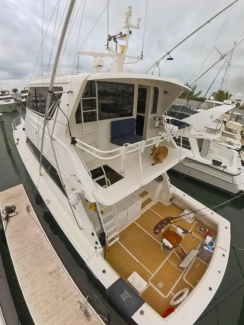 Slide: The Image of 1999 Viking 58 yacht docked, featuring spacious deck and modern design. - 4