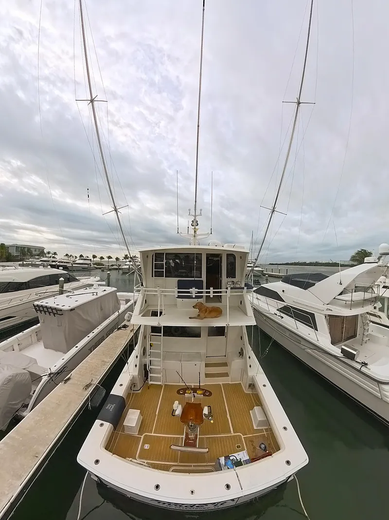 Slide: The Image of 1999 Viking 58 yacht docked at marina, view from above, cloudy sky. - 5