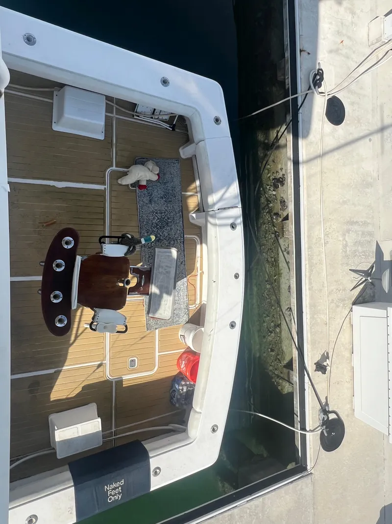 Slide: The Image of Overhead view of a 1999 Viking 58 EB boat docked at a marina. - 6