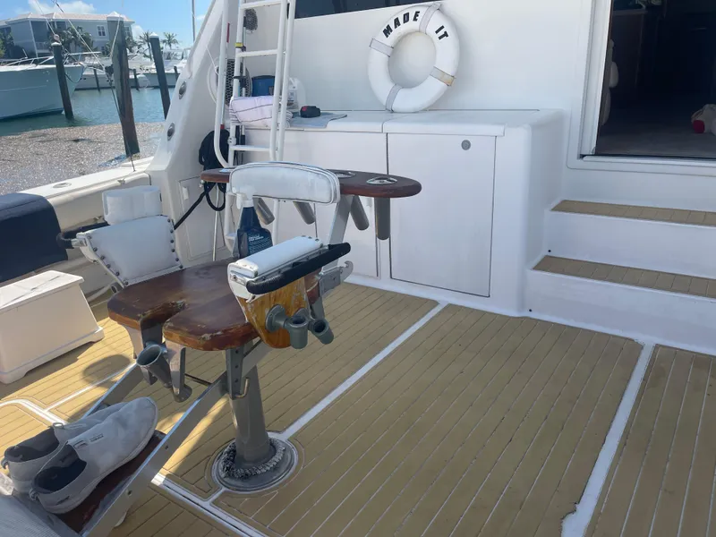 Slide: The Image of 1999 Viking 58 EB yacht deck with fishing chair and life preserver. - 8