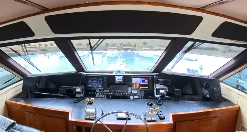 Slide: The Image of Cockpit of a 1999 Viking 58 yacht with navigation equipment and panoramic view. - 9