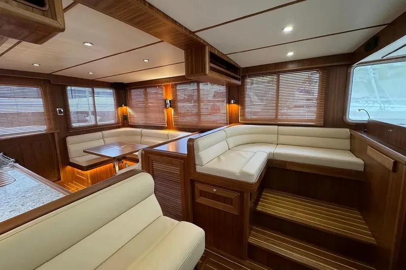 Slide: The Image of Luxurious interior of 2025 Helmsman Trawlers 38 Sedan with elegant wood finishes and plush seating. - 10