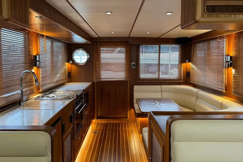Slide: The Image of Luxurious interior of 2025 Helmsman Trawlers 38 Sedan with wood finishes and modern amenities. - 12