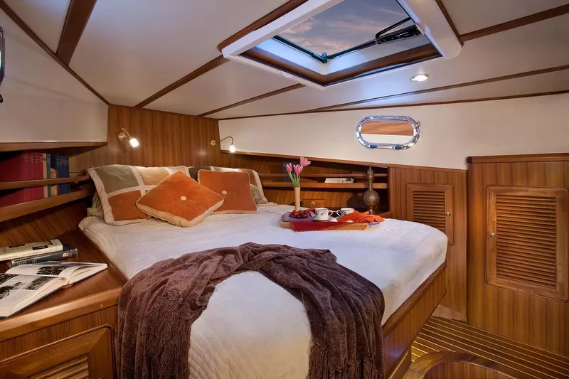 Slide: The Image of Luxurious cabin interior of 2025 Helmsman Trawlers 38 Sedan with cozy bedding. - 22