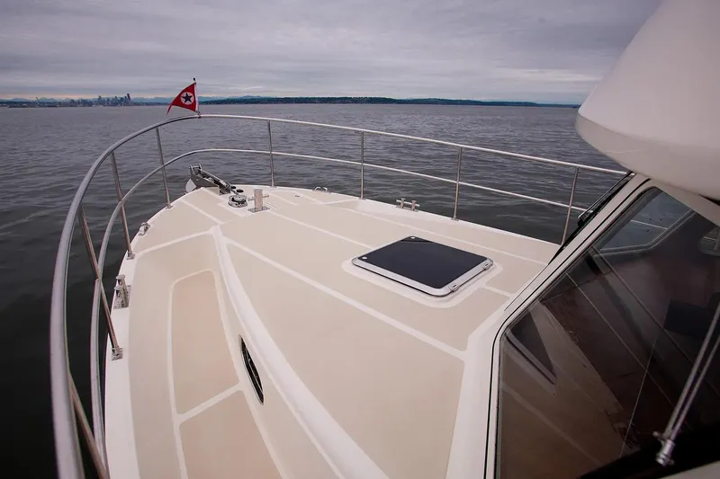 Slide: The Image of Helmsman Trawlers 38 Sedan 2025 yacht deck on calm waters. - 30