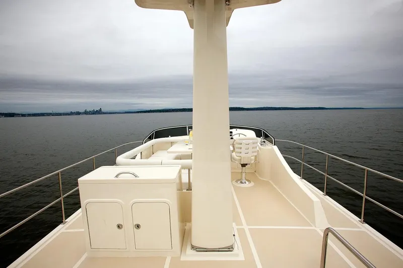 Slide: The Image of Helmsman Trawlers 38 Sedan 2025 on calm waters, showcasing spacious deck and seating. - 8