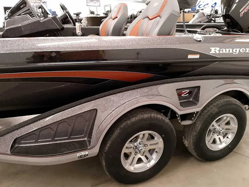 Slide: The Image of 2025 Ranger Z520 SC boat with dual axle trailer, sleek design, and comfortable seating. - 11