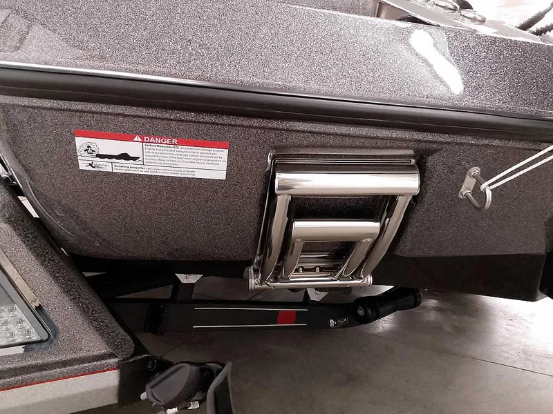 Slide: The Image of 2025 Ranger Z520 SC boat with a stainless steel ladder and safety warning label. - 12