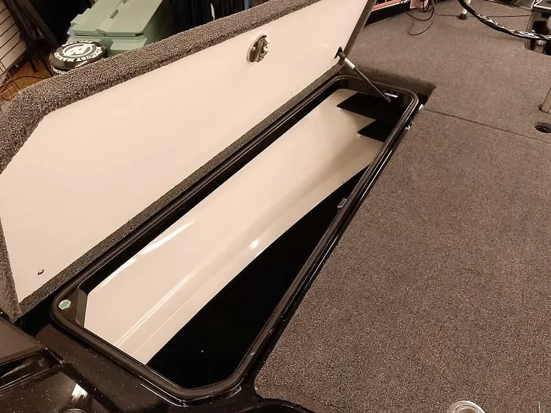 Slide: The Image of 2025 Ranger Z520 SC boat storage compartment with open lid, showcasing spacious interior. - 19