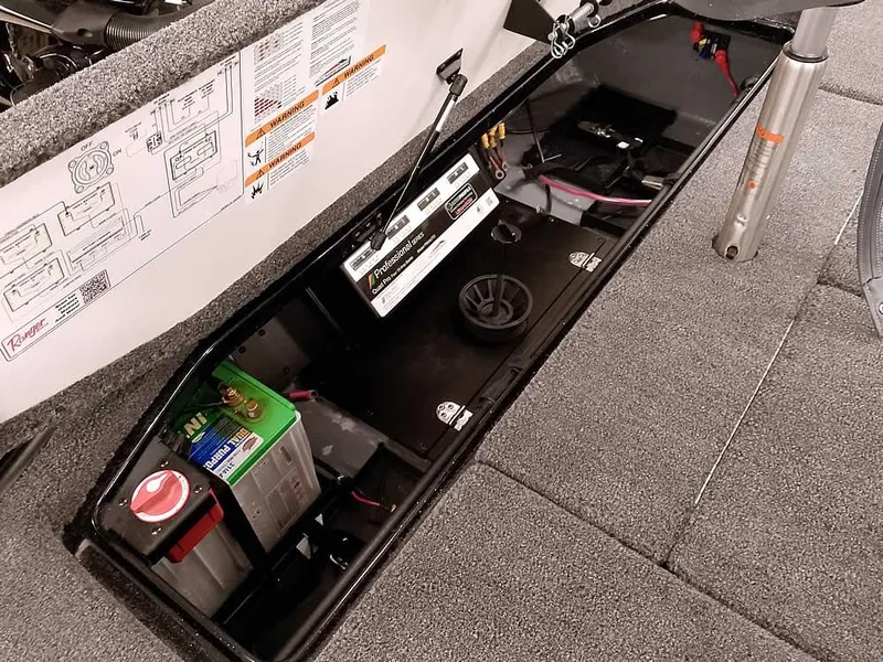Slide: The Image of 2025 Ranger Z520 SC boat battery compartment with wiring and components. - 36