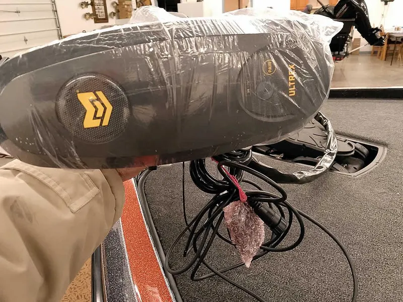 Slide: The Image of 2025 Ranger Z520 SC boat with wrapped trolling motor, cables visible, in a garage setting. - 9